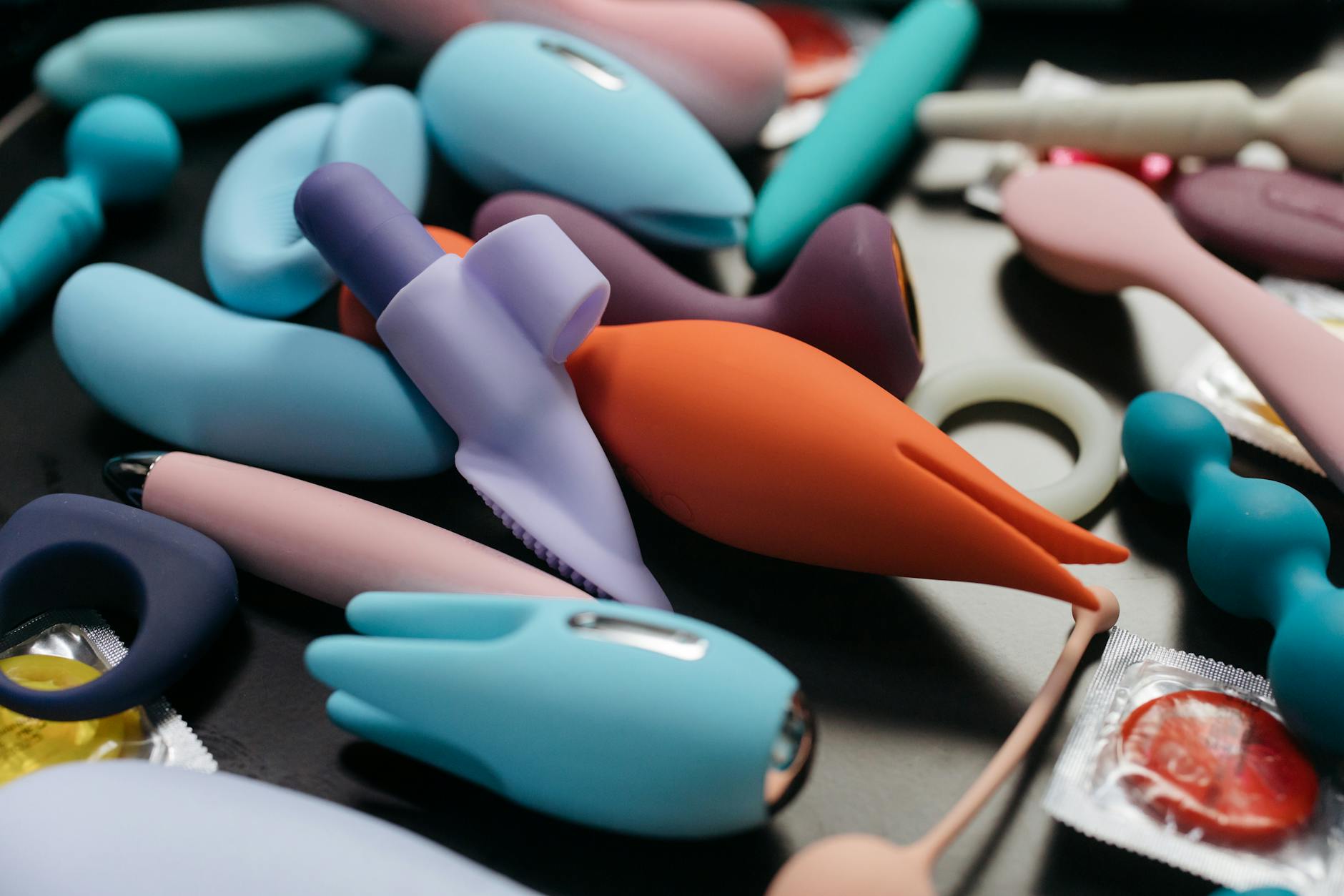 Close-up of hands holding a sleek blue vibrator, representing safe exploration and personal control