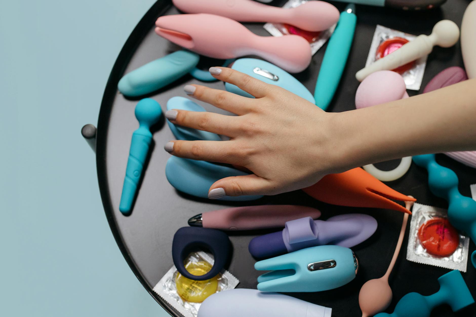A hand holding a vibrator, showing modern sensuality and self-care