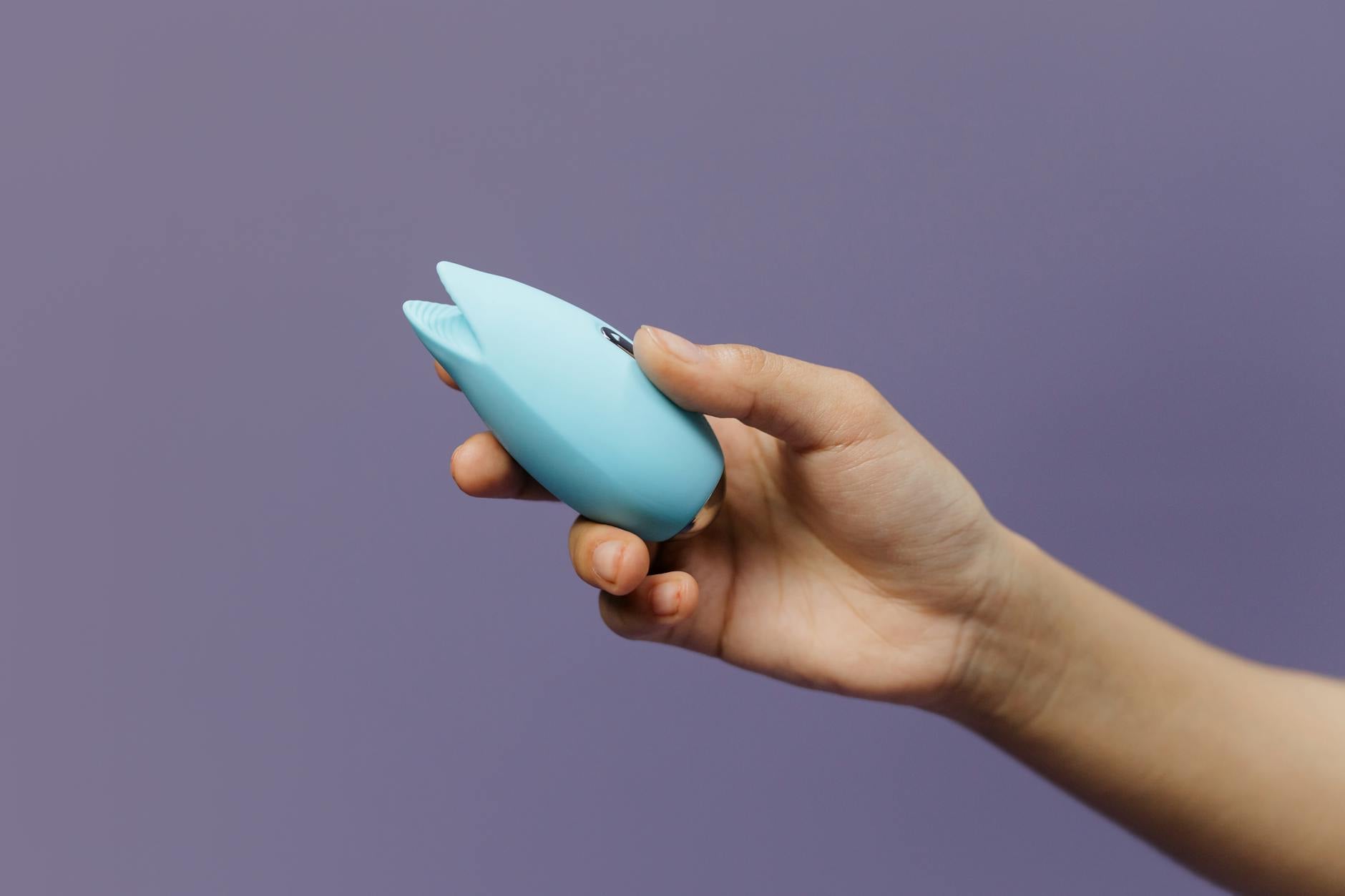 A blue silicone lemon vibrator held in hand, symbolizing self-directed pleasure and personal reclamation